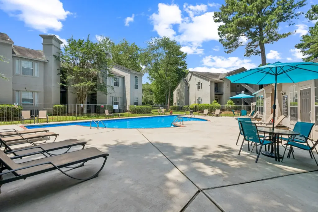An outdoor pool with a pool deck adjacent to it