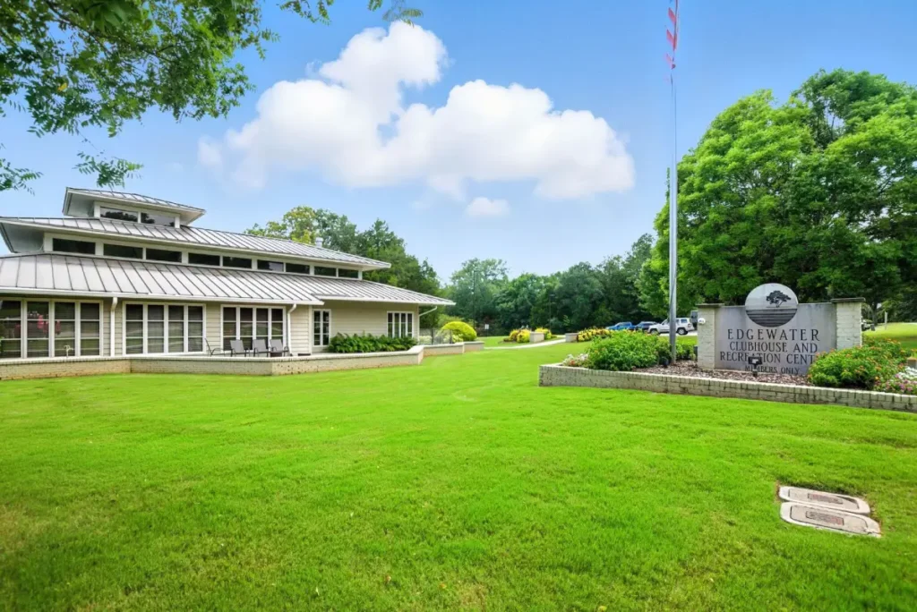A three-story building with a sign in front of it that reads "Edgewater Clubhouse and Recreation Center"