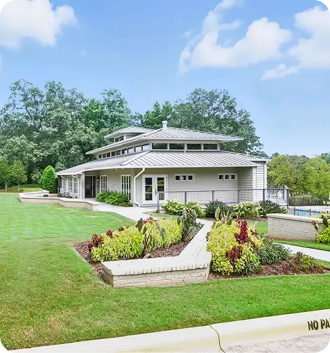 The Landing Apartments at Edgewater clubhouse with a green lawn around it