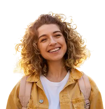 A woman in a yellow jacket and a backpack on smiles for the camera